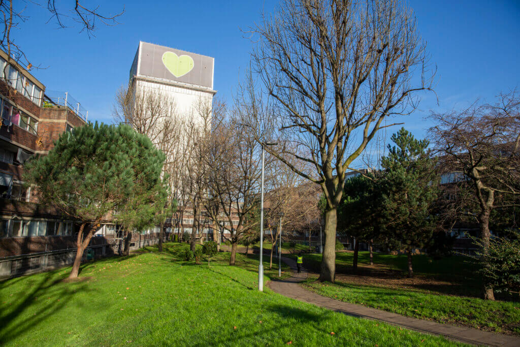 Image of Grenfell tower, with Green space in foreground.