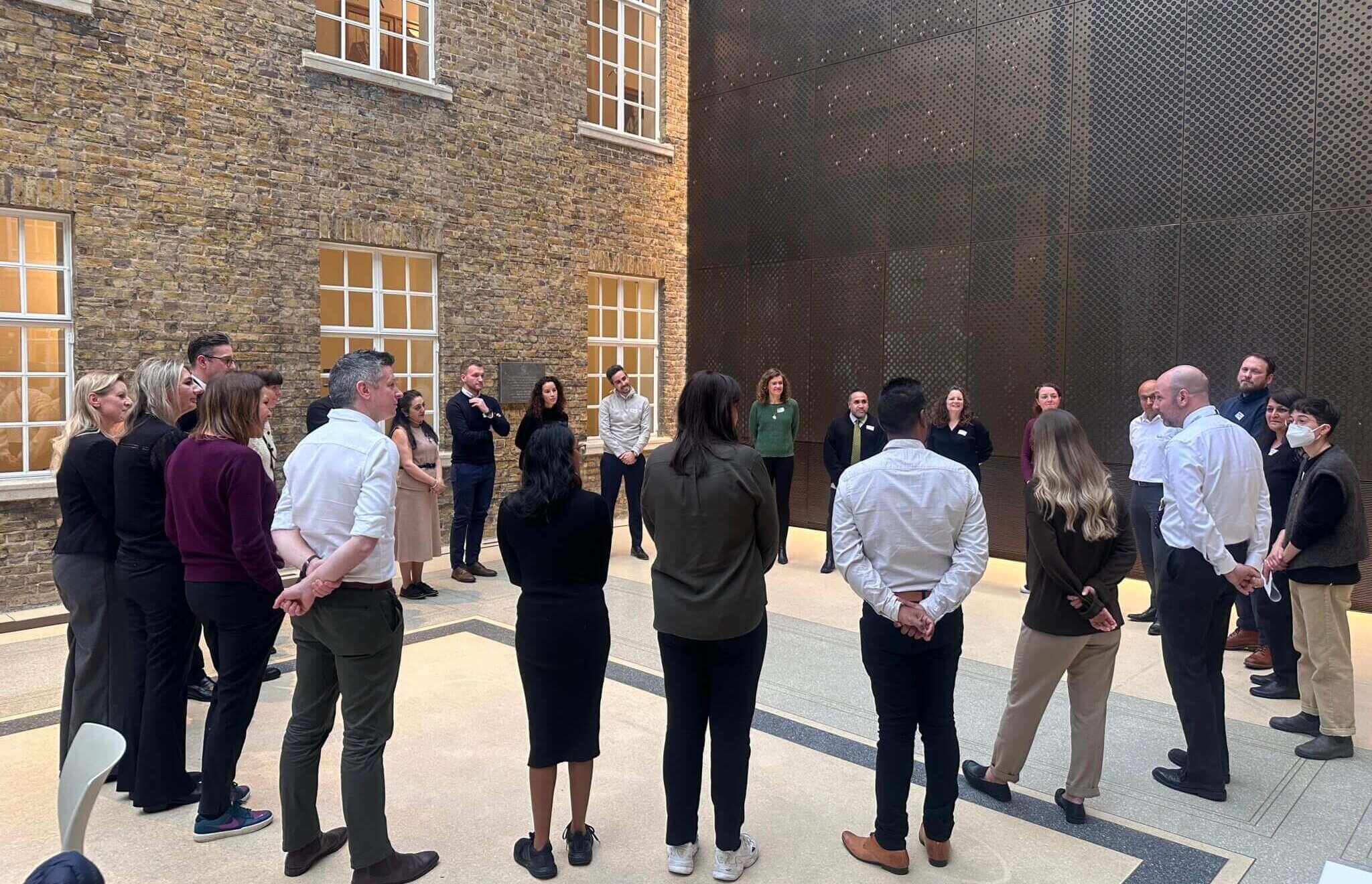 Group of participants standing in a circle at a workshop